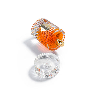 Perfume bottle with gold cap on a white background